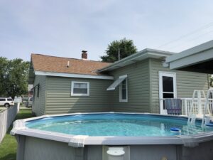 A house with newly installed light green siding completed by Freeman Exteriors in Danville, IL.