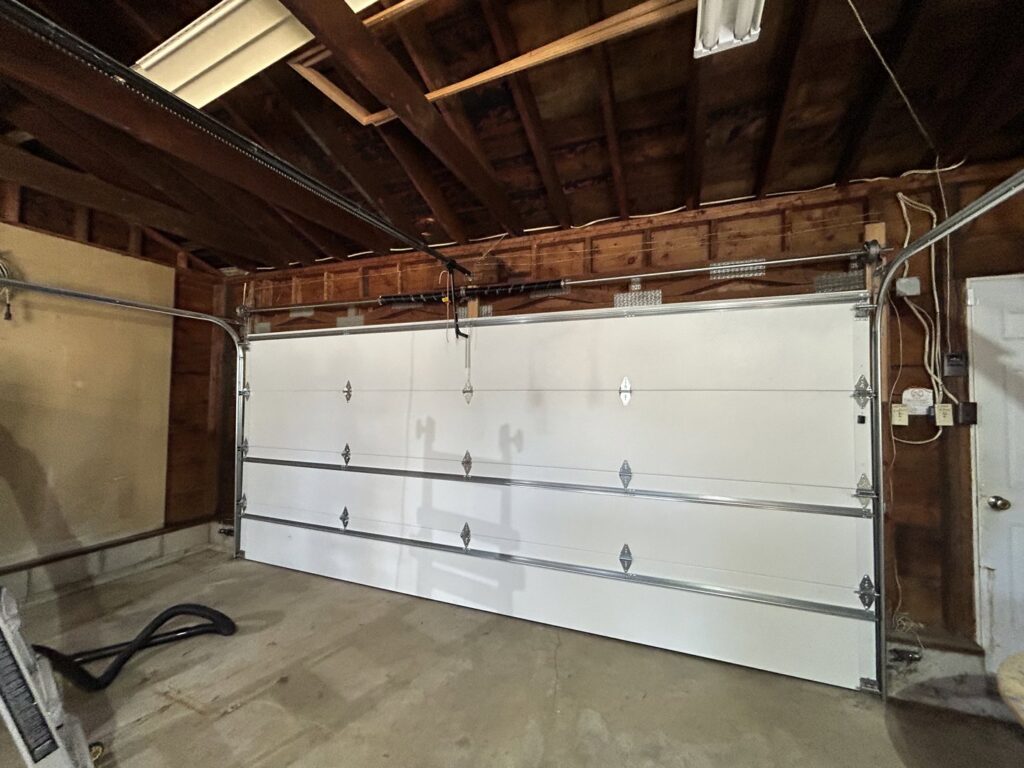 Interior view of a newly installed white garage door by Cedar Valley Garage Doors in Waterloo, IA