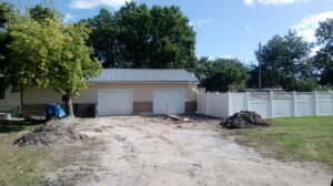 Two newly installed white garage doors on a building, showcasing work by Bob McDonald Garage Door LLC in Columbus, NE.