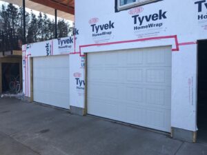 New white panel garage doors installed on a residential construction project by Elite Door in Winchester, CA.