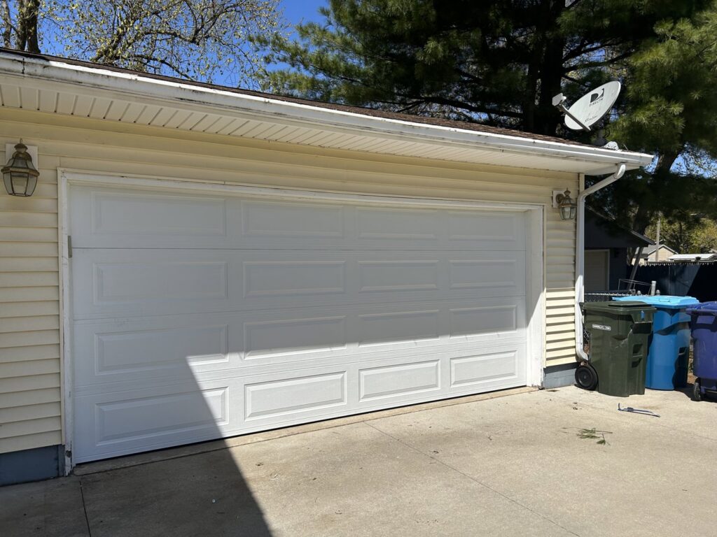 Newly installed white residential garage door by Cedar Valley Garage Doors in Waterloo, IA