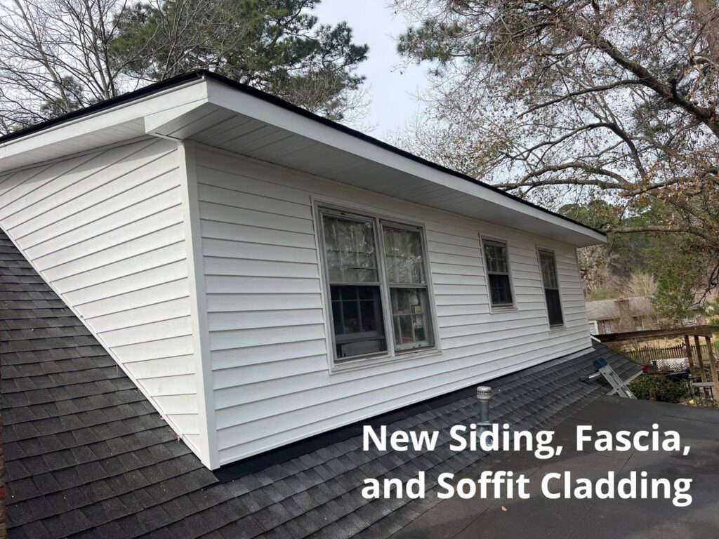 New white siding, fascia, and soffit cladding installed on a house by Powell Roofing in Ladson, SC.