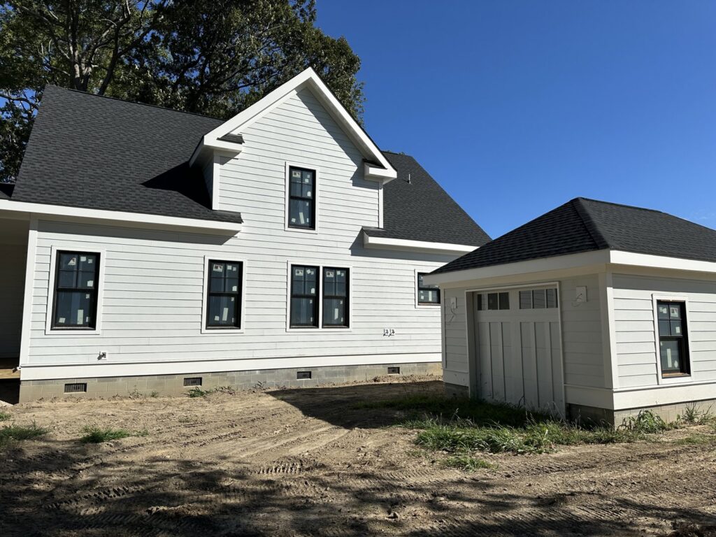 A newly built house featuring crisp white siding installed by Cordell Exteriors Inc in Chesapeake, VA