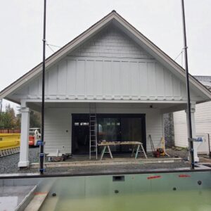 New white siding and shake installation on a house under construction by Ideal Siding Dallas, TX.