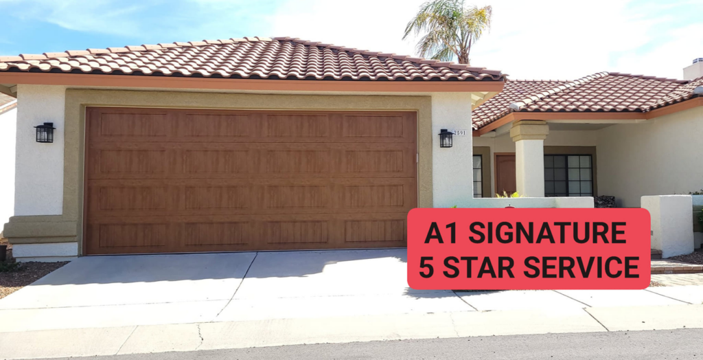 A beautiful new wood-grain garage door installed on a house by A1 Garage Guy Wes in Picture Rocks, AZ, offering 5-star service.