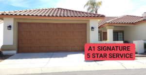 A beautiful new wood-grain garage door installed on a house by A1 Garage Guy Wes in Picture Rocks, AZ, offering 5-star service.