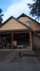 New wood siding being installed on the gables of a house by Action Roofing and Siding Co in South Saint Paul, MN