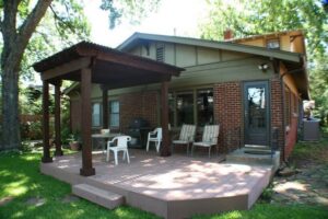 A modern house featuring newly installed blue horizontal siding and a gray roof by Arrow Exteriors Inc. in Topeka, KS