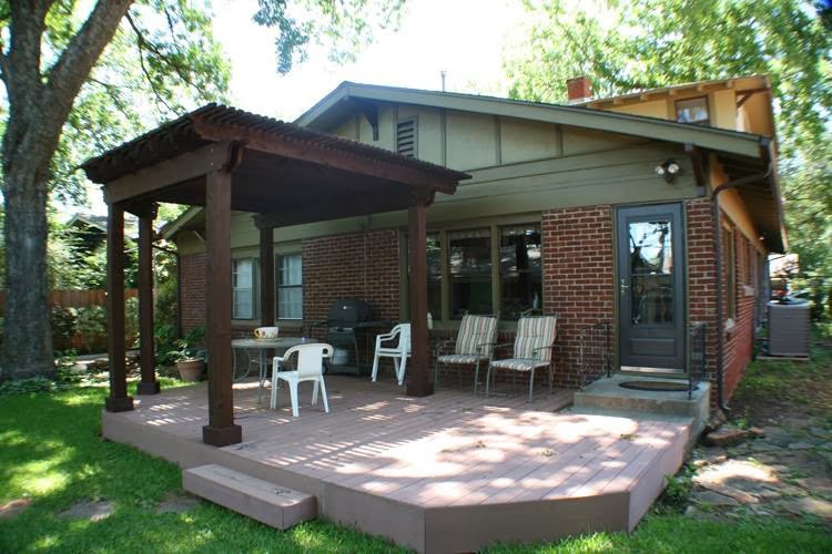 A modern house featuring newly installed blue horizontal siding and a gray roof by Arrow Exteriors Inc. in Topeka, KS