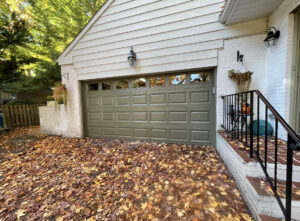 A newly installed brown garage door on a house by Delaware Express Garage Door Service in Wilmington, DE