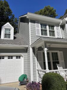 A residential home showcasing newly installed gray siding and crisp white trim by HP Exteriors in Woodstock, GA