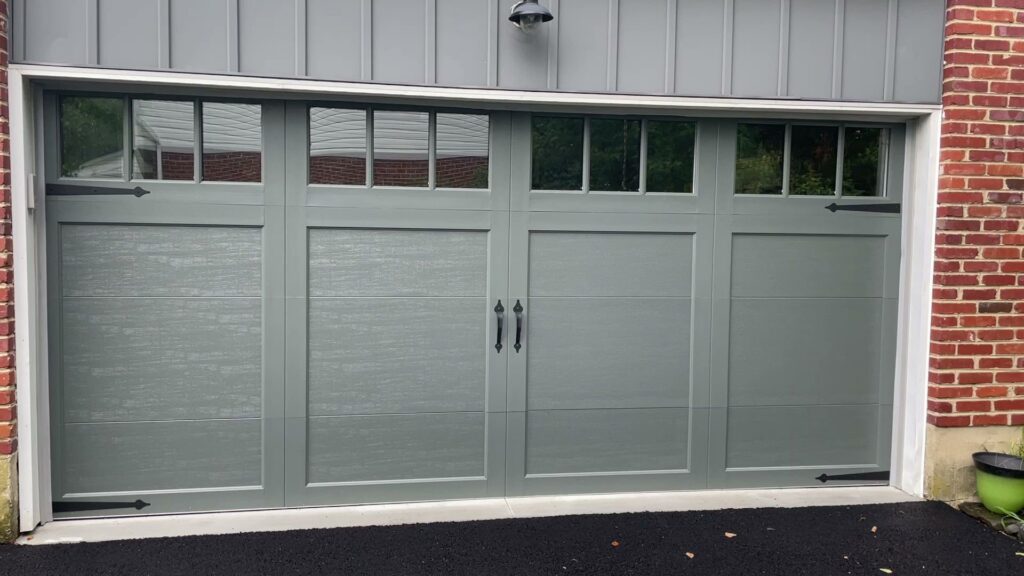 A newly installed grey garage door with decorative hardware by Delaware Express Garage Door Service in Wilmington, DE