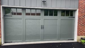 A newly installed grey garage door with decorative hardware by Delaware Express Garage Door Service in Wilmington, DE