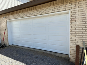 A newly installed white panel garage door by Espada Garage Door and Gate, LLC, providing quality service in Las Cruces, NM.