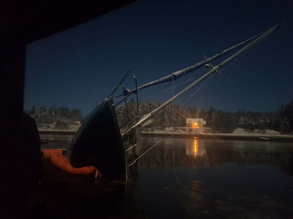 Nighttime salvage operation by Downeast Marine Towing, LLC for a partially sunk sailboat in Eastport, ME.