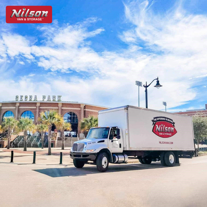 A Nilson Van and Storage moving truck parked in front of Segra Park in Columbia, SC.