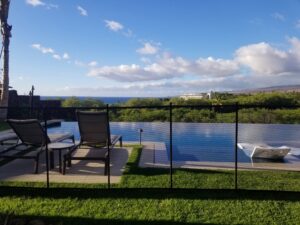 An ocean view pool fence installation by Guardian Pool Fence Systems of Hawaii, providing safety for an infinity pool in Honolulu, HI.