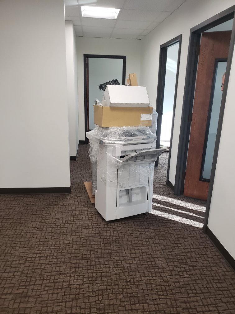 A large office copier machine carefully wrapped for moving by Ron's Moving in Little Rock, AR.