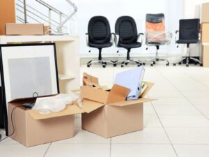 An office space with open moving boxes and office chairs, indicating an office relocation by Las Vegas Moving Pros LLC in Las Vegas, NV.
