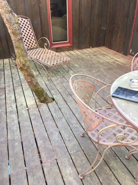 Old and worn patio furniture on a wooden deck, ready for general junk removal by Athens Pressure Washing Services in Athens, GA.