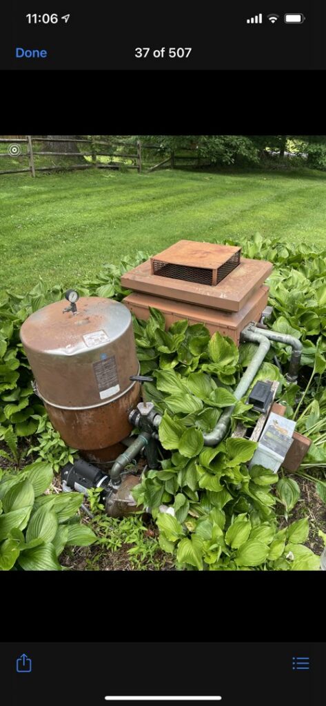 Old and rusty pool equipment overgrown with plants, indicating a need for repair or replacement services from Chlorine Clean Pool Services in Wilmington, DE.