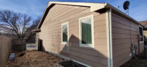 An older home with weathered brown siding, ready for replacement by River City Exteriors in San Antonio, TX