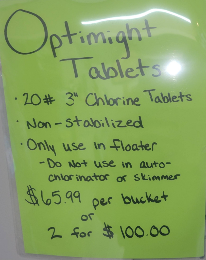A sign advertising Optimight Tablets chlorine for pool maintenance at Pool Queen in Fairmont, WV.