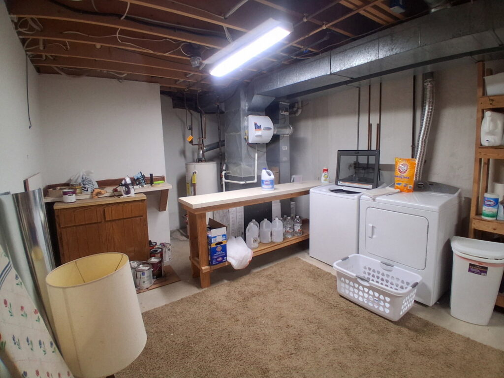 An organized basement storage area with neatly arranged shelves, showcasing the results of professional cleaning by CleanSlate Cleaning Company in Lansing, MI.