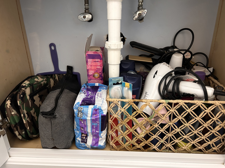 A neatly organized bathroom cabinet after professional cleaning by On Course Cleaning in Fayetteville, NC.