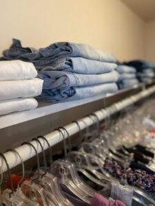 Neatly folded clothes and organized shelves in a closet by Consciously Cleared & Contained LLC in Elsmere, DE.
