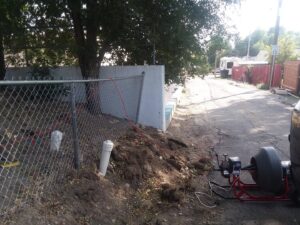 An outdoor drain cleaning service in progress with equipment near a cleanout by Central Wyoming Drain Service in Casper, WY.