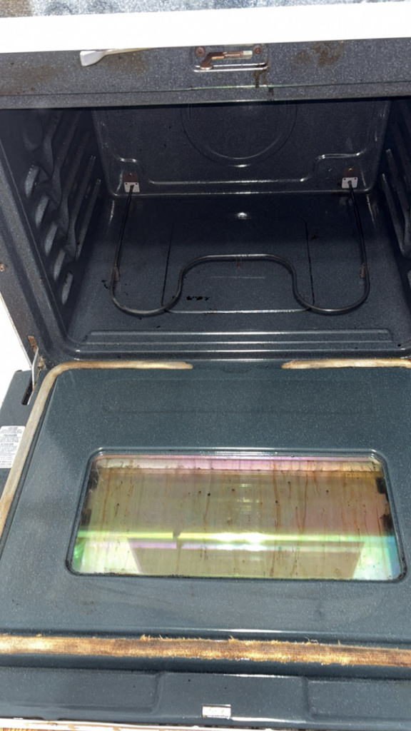 A partially cleaned oven interior, showcasing the progress of a house cleaner job by Down And Dirty Cleaning in Clayton, NC.