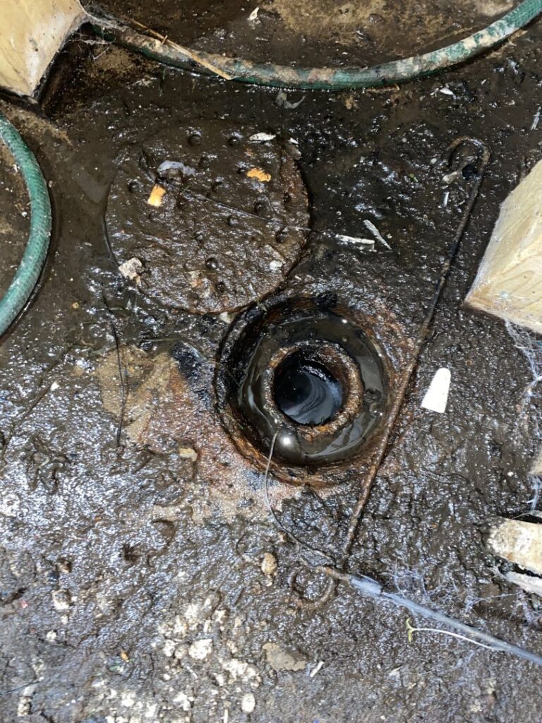 Dirty, overflowing drain or sump pump area, indicating water or sewage backup cleanup by Acclaim Restoration in Harrisburg, PA