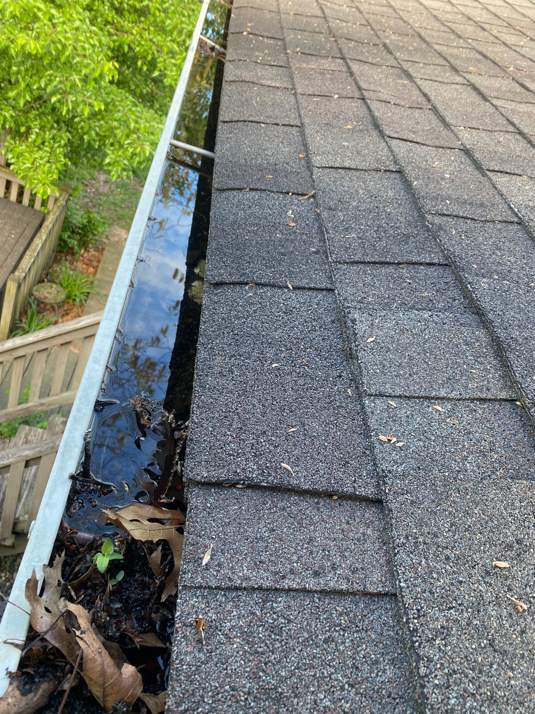 An overflowing gutter filled with water and debris, indicating potential water damage issues, addressed by Valor Restoration in Richmond, KY