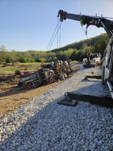 McDowell Wrecker Service recovering an overturned semi-trailer with a heavy-duty tow truck in Springfield, MO.