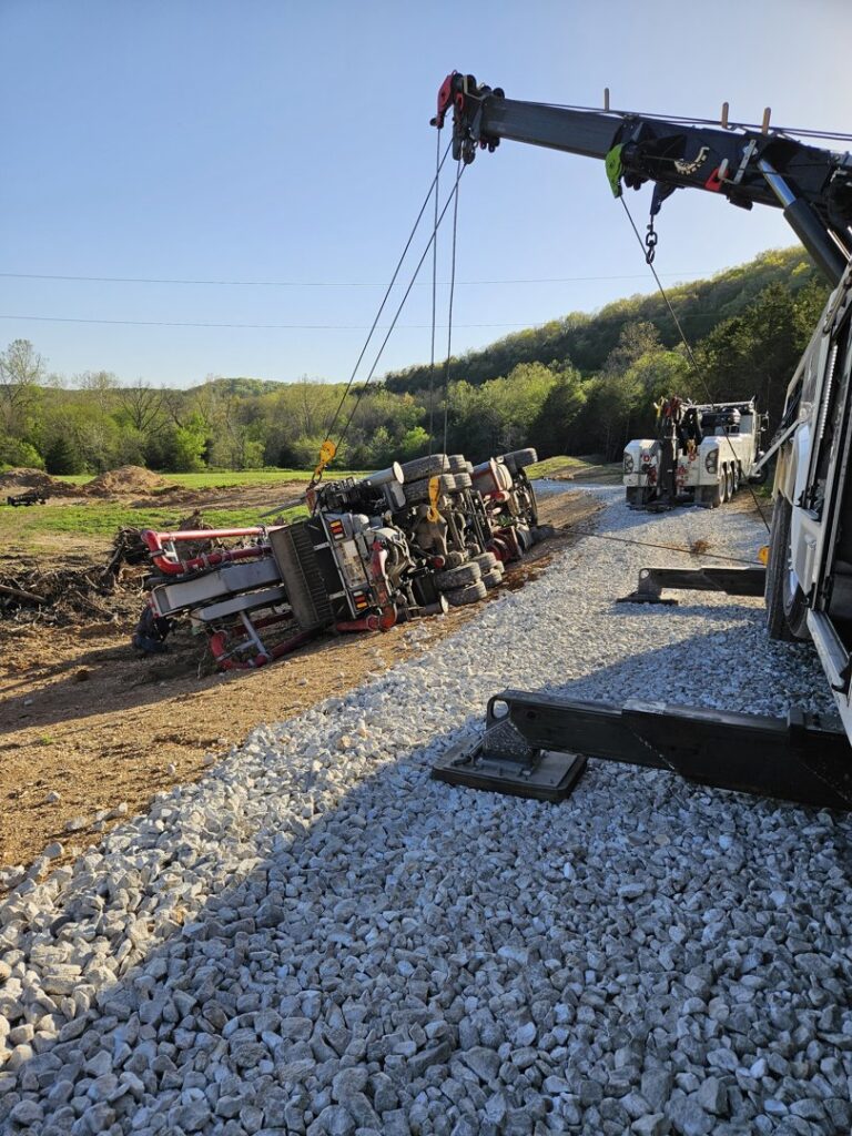 McDowell Wrecker Service recovering an overturned semi-trailer with a heavy-duty tow truck in Springfield, MO.