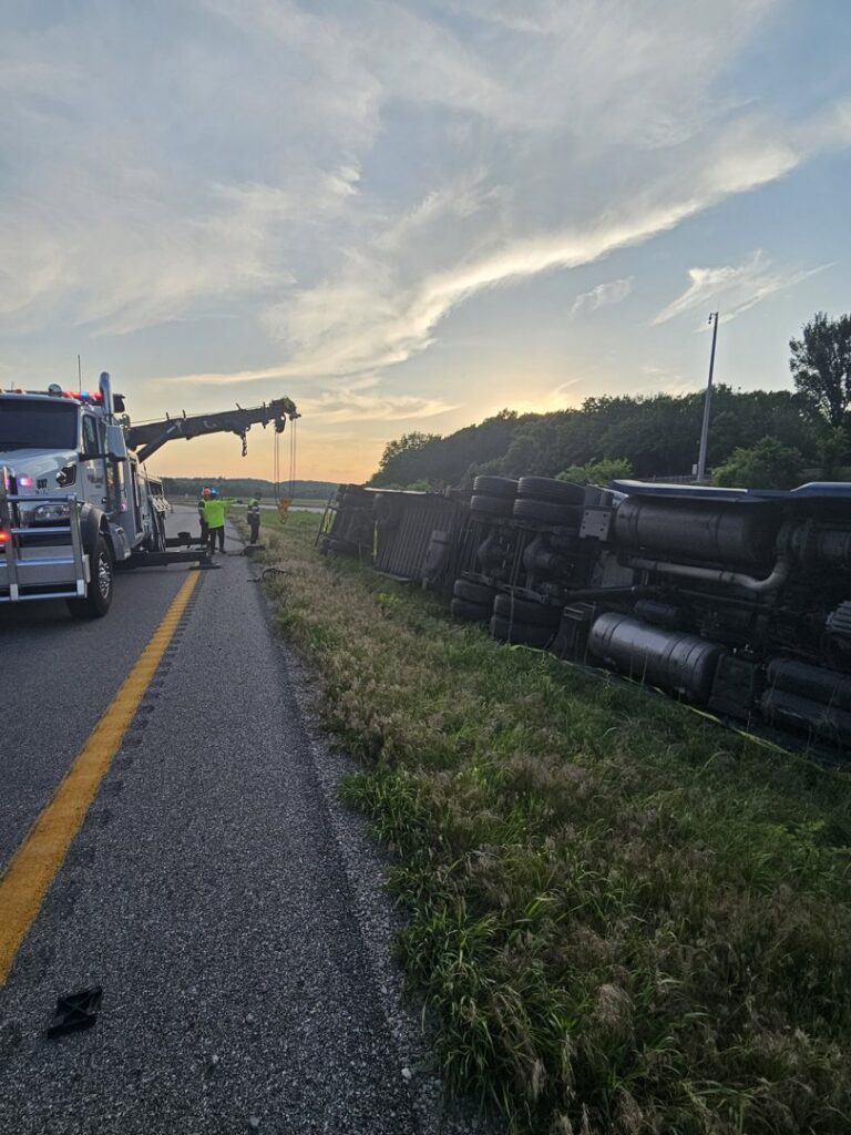 McDowell Wrecker Service recovering an overturned semi-trailer at sunset in Springfield, MO.