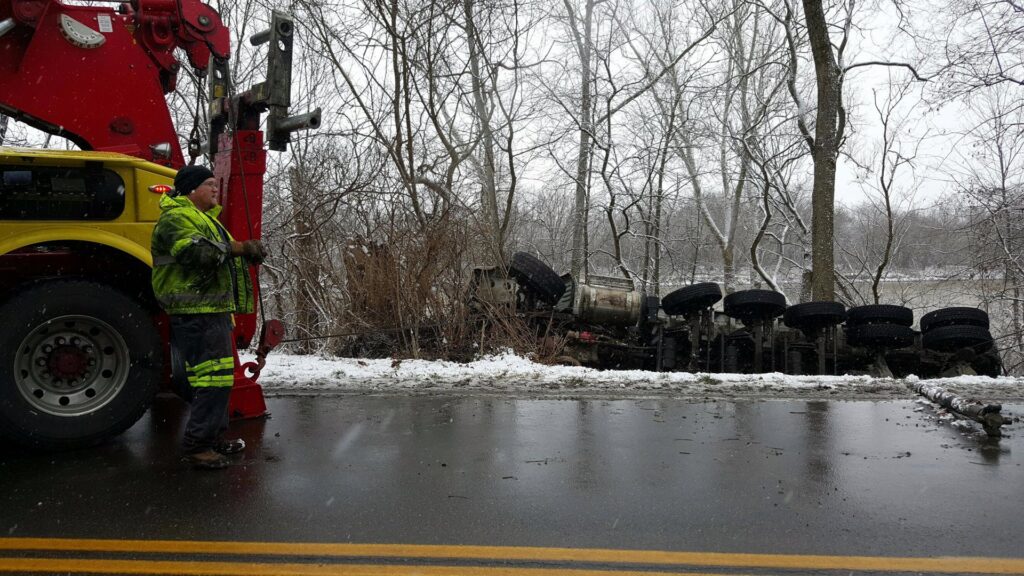 Bevis Towing performing an overturned tanker truck recovery from a snowy ditch in Cincinnati, OH.