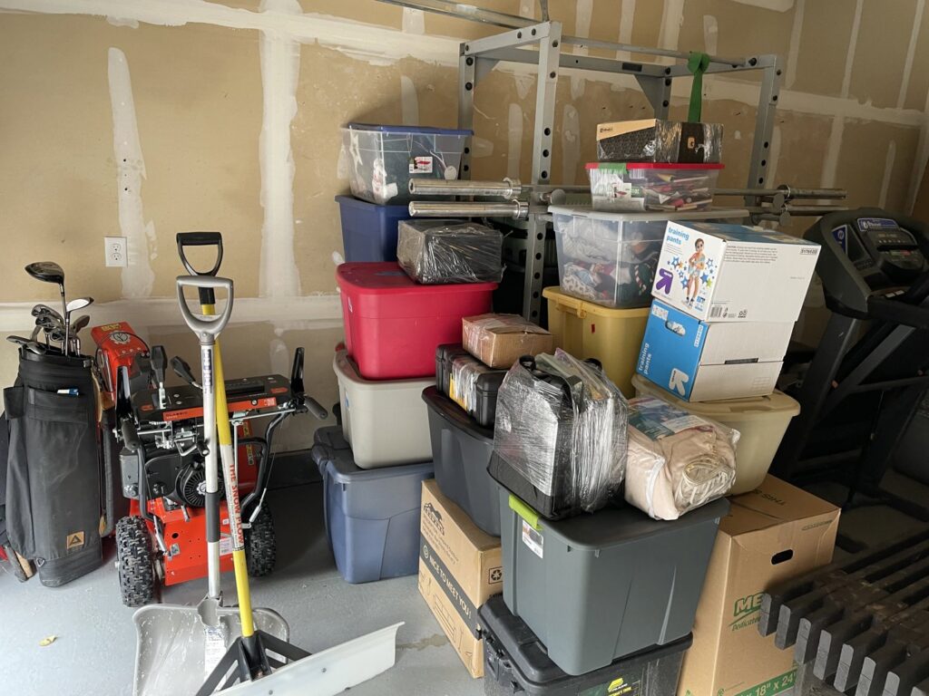 A garage filled with packed boxes and various items, ready for moving by Next Step Moving in Eau Claire, WI.