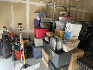 A garage filled with packed boxes and various items, ready for moving by Next Step Moving in Eau Claire, WI.
