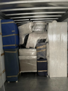 A moving truck interior packed with securely wrapped furniture by CNZ Moving in Raleigh, NC.