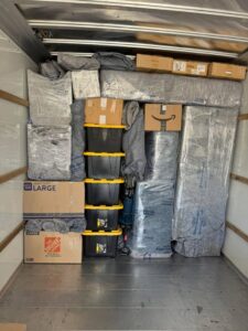 The interior of a moving truck fully packed with wrapped furniture, boxes, and bins by Packsen Moving in San Antonio, TX.