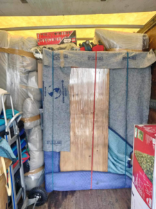 Furniture securely packed and strapped inside a moving truck, ready for transport by E.L.I Movers LLC in Houston, TX.