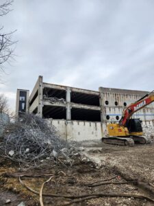 A partially demolished concrete structure with rebar and debris, handled by DeCarlo Demolition Company in Des Moines, IA.