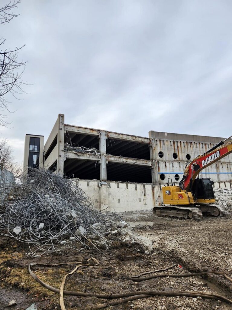 A partially demolished concrete structure with rebar and debris, handled by DeCarlo Demolition Company in Des Moines, IA.