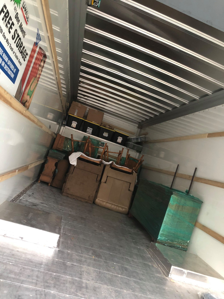 Inside a partially loaded moving truck with furniture and boxes by Natural State Moving in Conway, AR.