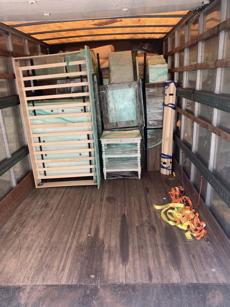 A partially packed moving truck with wrapped furniture and moving supplies from allpromovingservice in San Antonio, TX.