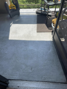 A patio floor showing a clean section next to a dirty section, indicating a cleaning job by Ragin Cleaning Services in Owings Mills, MD.
