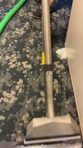 A professional carpet cleaning wand performing water extraction on a patterned carpet by Renue Systems Of Oahu in Honolulu, HI