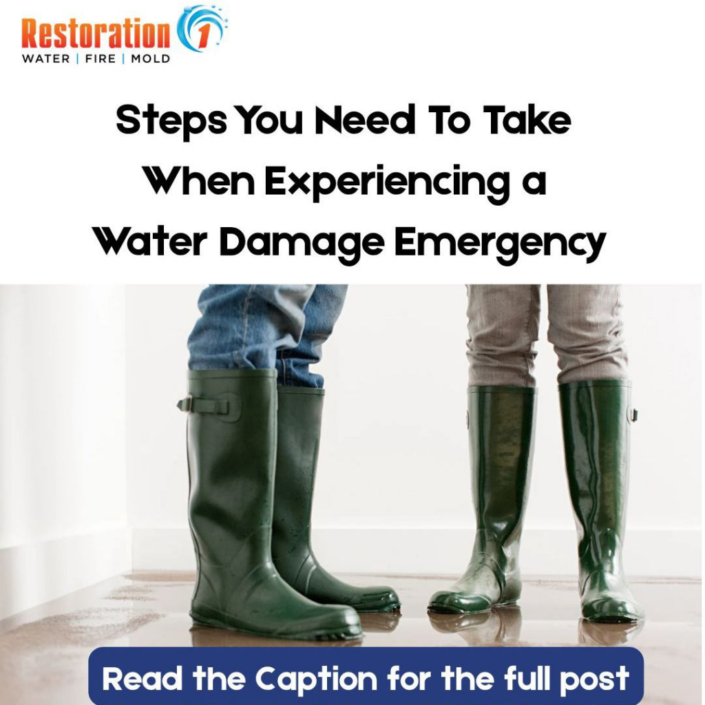 People wearing rubber boots standing in a puddle of water on a floor, indicating water damage, by Restoration 1 of NWA in Bentonville, AR.